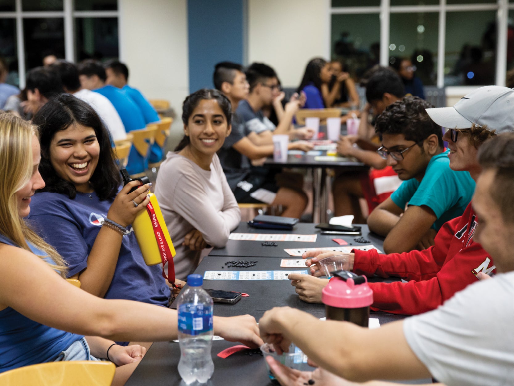 A group of UMD students laugh while playing BINGO in STAMP