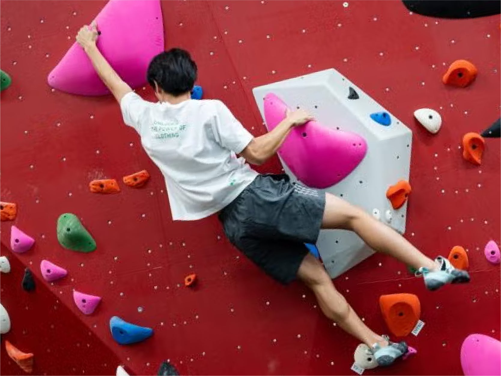 A student climbs on RecWell's bouldering wall