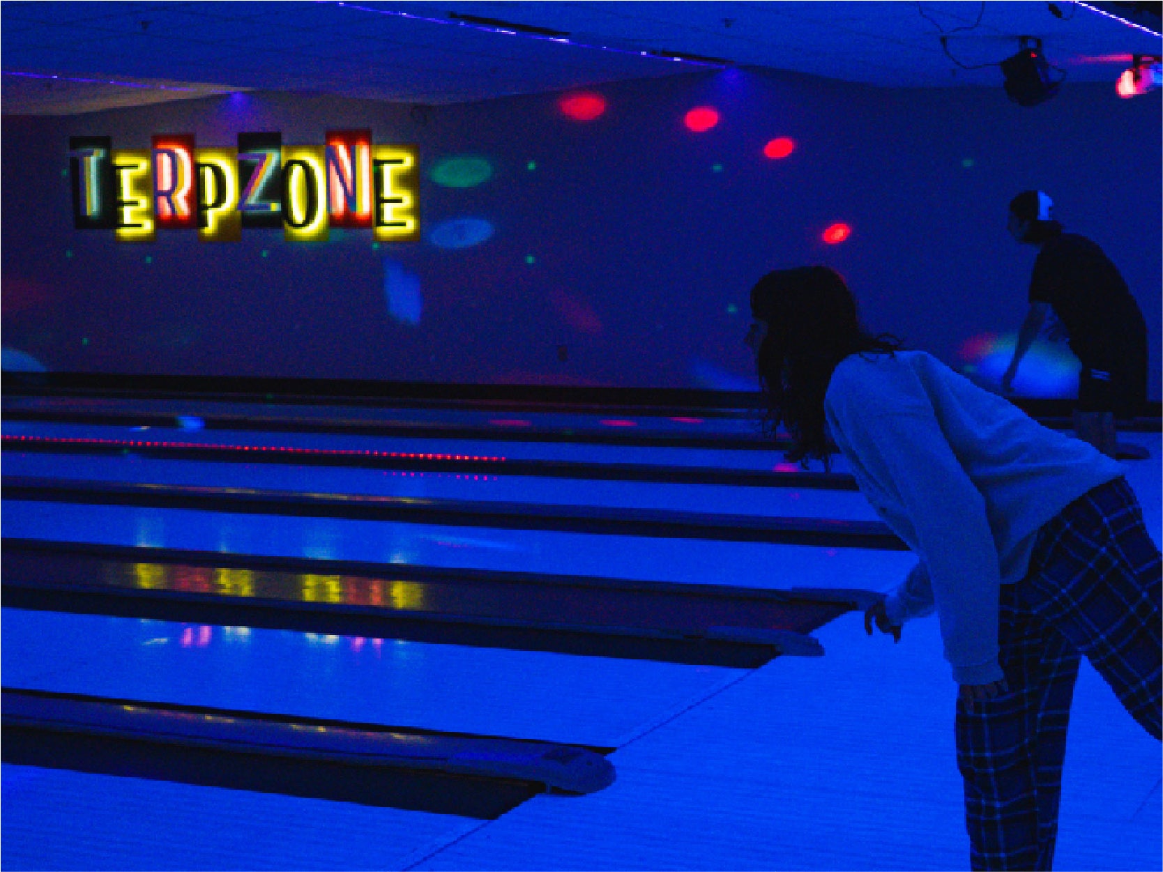Students bowl under black light at the TerpZone