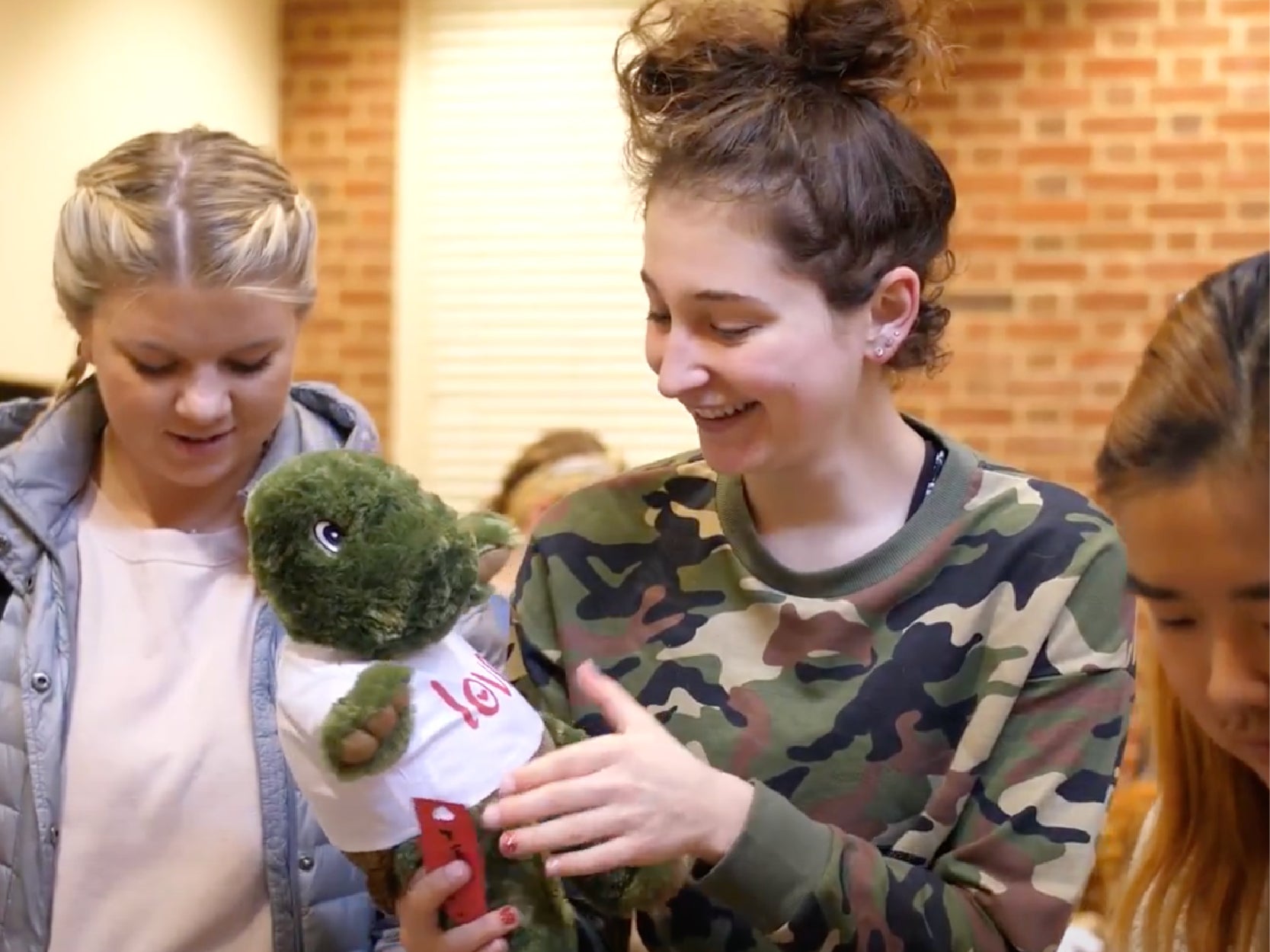 A photo of two students smiling while holding a "Build A Terp" project