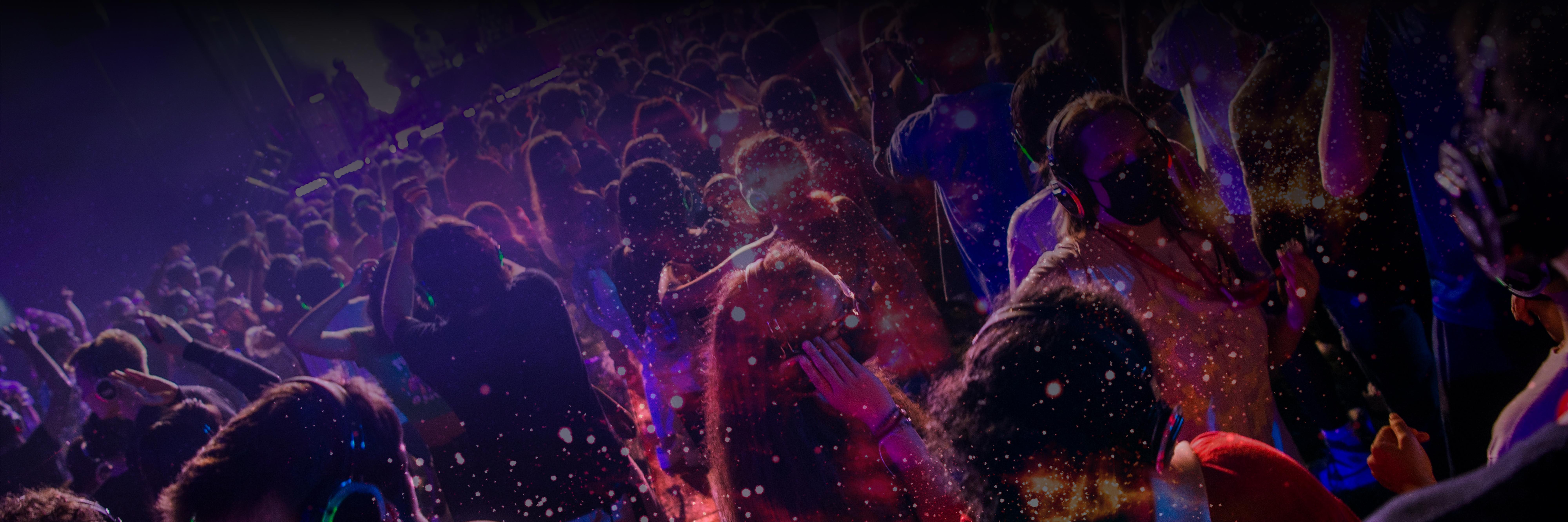 Image of students dancing at a silent disco, with a desaturated nebula pattern overlaid
